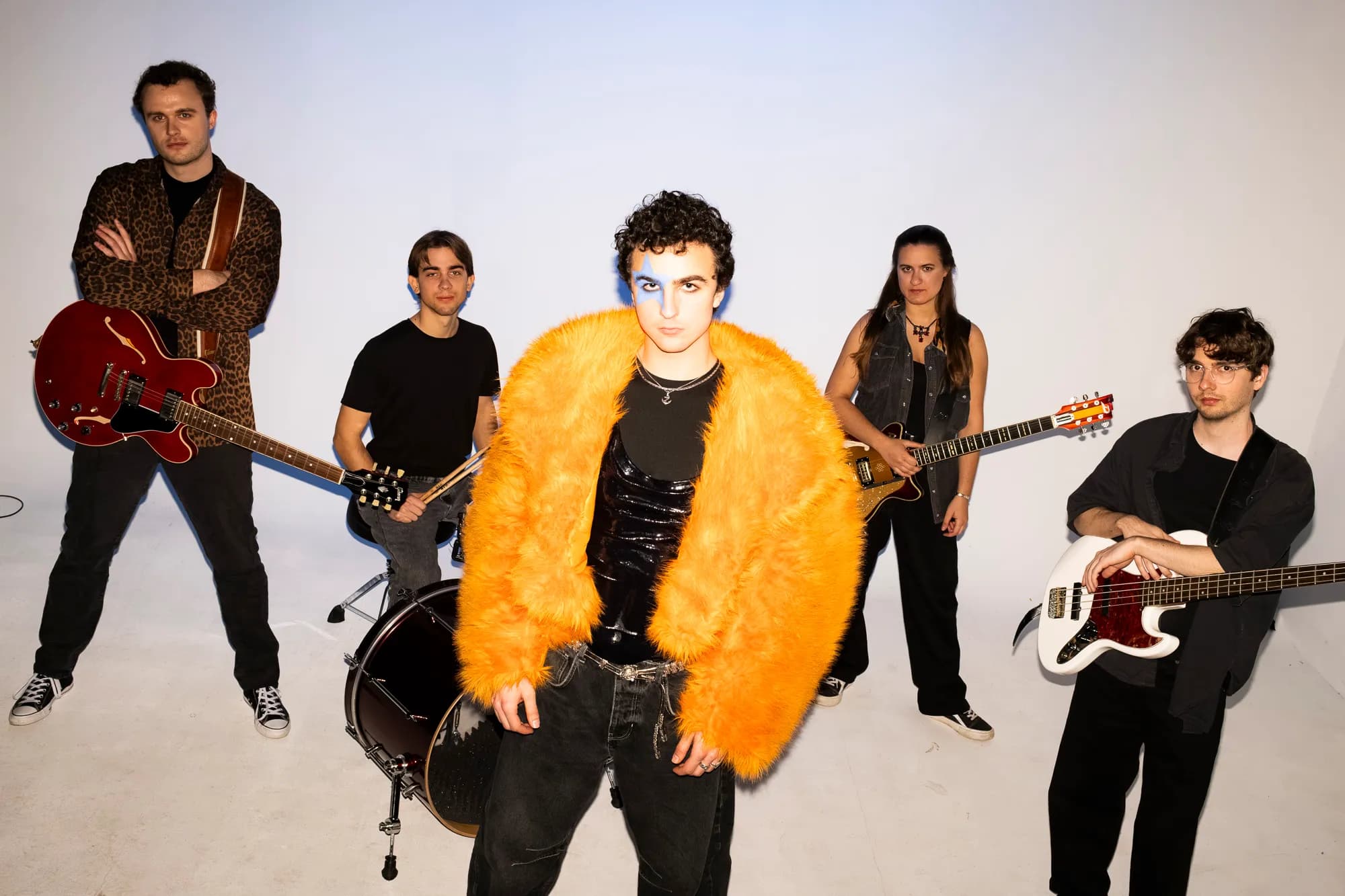 COSMÓ and band standing with instruments