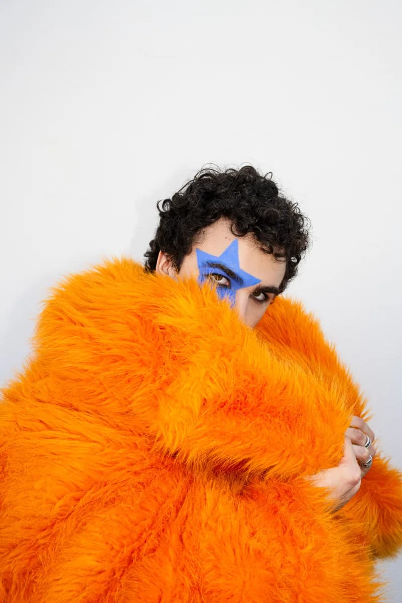 COSMÓ in orange fur coat